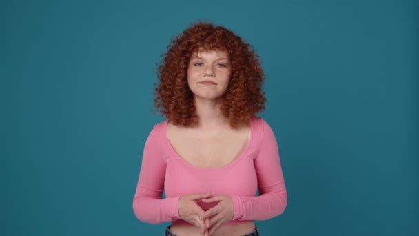 Positive Curly Haired Redhead Woman Wearing Pink Shirt Agrees Something — 图库视频影像