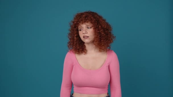 Upset Curly Haired Redhead Woman Wearing Pink Shirt Looking Blue — Stock video