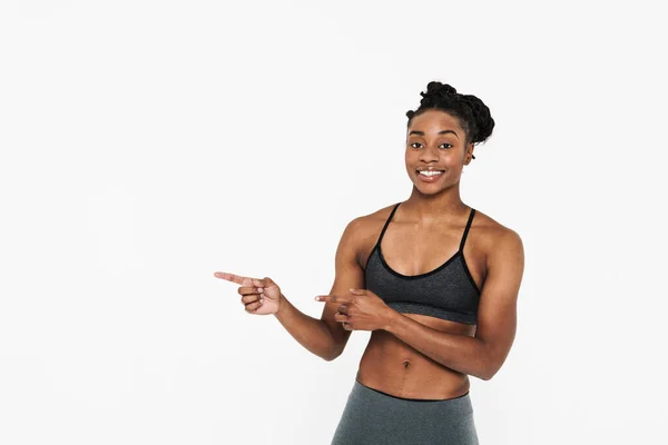 Young Black Sportswoman Smiling Pointing Finger Aside Isolated White Background — Fotografia de Stock