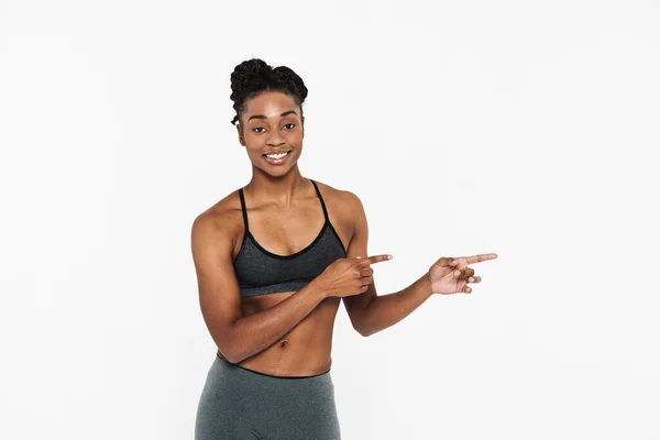 Young Black Sportswoman Smiling Pointing Finger Aside Isolated White Background — Foto de Stock