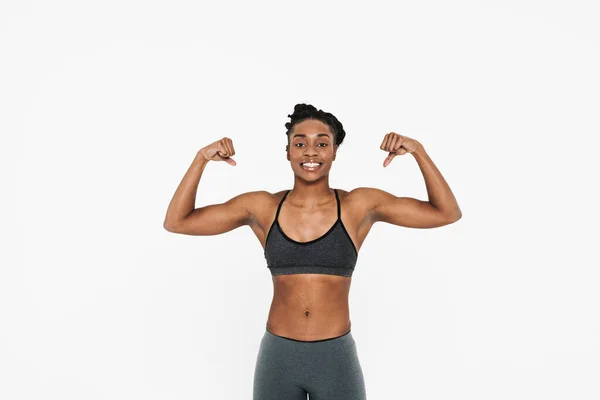 Young Black Sportswoman Smiling Looking Showing Her Biceps Isolated White — Foto de Stock