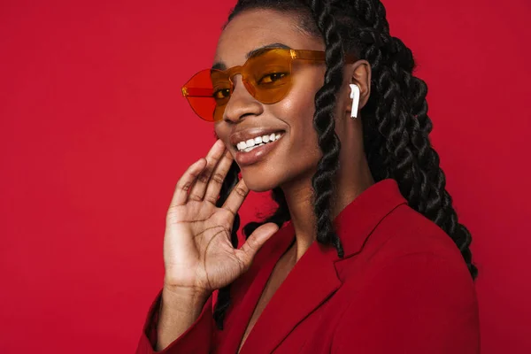 Black Young Woman Smiling While Listening Music Earphones Isolated Red — Foto Stock