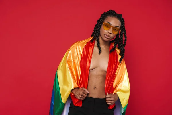 Black Shirtless Woman Sunglasses Posing Rainbow Flag Isolated Red Background — Fotografia de Stock