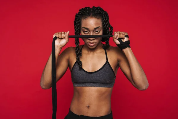 Young Black Sportswoman Wearing Bra Posing Rope Isolated Red Background — Foto de Stock
