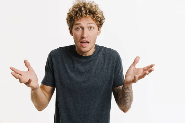 Young Curly Man Expressing Surprise Gesturing Camera Isolated White Wall — 스톡 사진