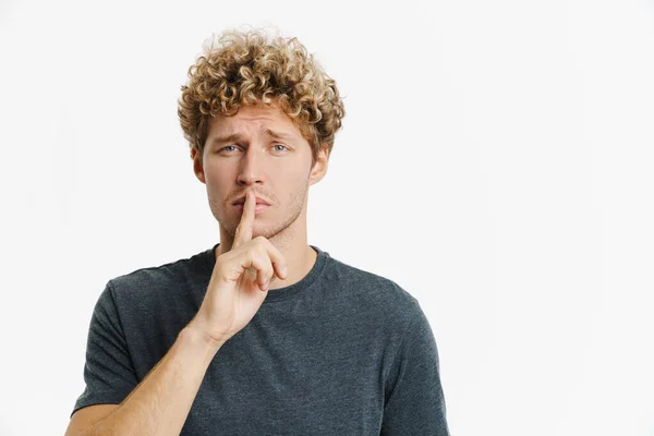 Young Blonde Man Frowning While Making Winner Gesture Isolated White — Stockfoto
