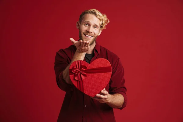 Blonde Man Holding Copyspace While Showing Heart Gift Box Isolated — Stock Photo, Image