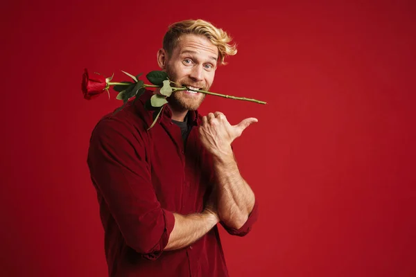 White Man Pointing Finger Aside While Holding Rose His Mouth — Stock Photo, Image