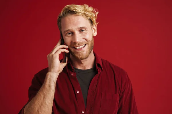 Bearded Blonde Man Smiling Talking Mobile Phone Isolated Red Background —  Fotos de Stock
