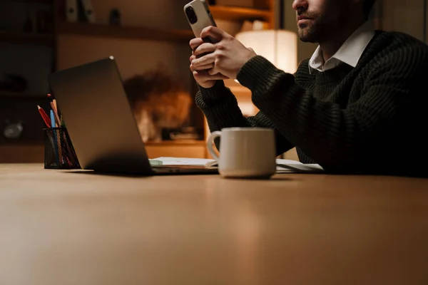 Young Bristle Man Using Mobile Phone While Working Laptop Office —  Fotos de Stock