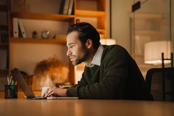 Young Bristle Man Working Laptop While Sitting Desk Office — Fotografia de Stock