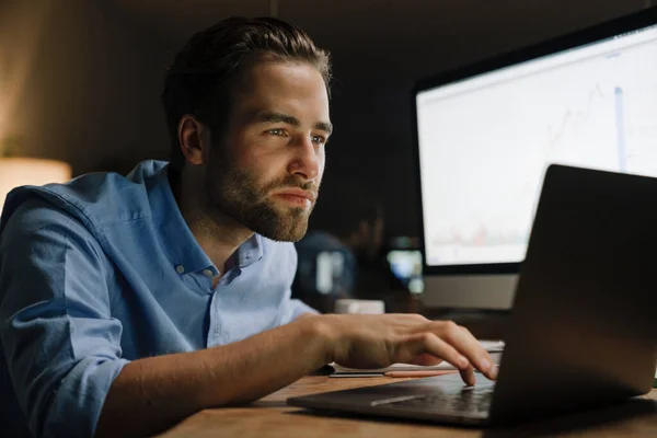 Young Man Working Laptop Computer While Sitting Desk Office — Stockfoto