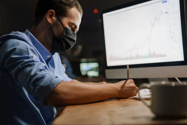 Young White Man Protective Mask Writing Notes While Working Office — Foto de Stock