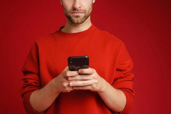 European Young Man Wearing Long Sleeve Using Cellphone Isolated Red — Foto de Stock