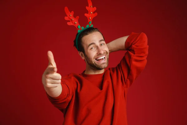 Young Man Wearing Christmas Antlers Pointing Finger Camera Isolated Red — 스톡 사진