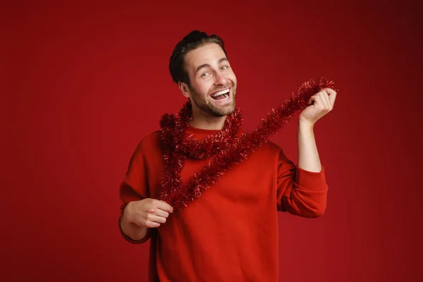Young Bristle Man Laughing Making Fun Tinsel Isolated Red Background —  Fotos de Stock
