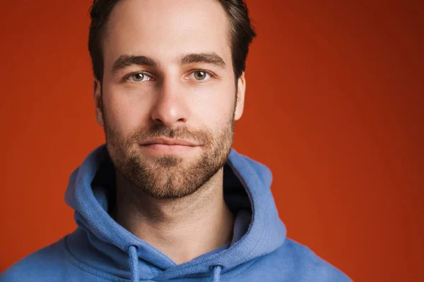 Young Bristle Man Wearing Hoodie Posing Looking Camera Isolated Red — Φωτογραφία Αρχείου