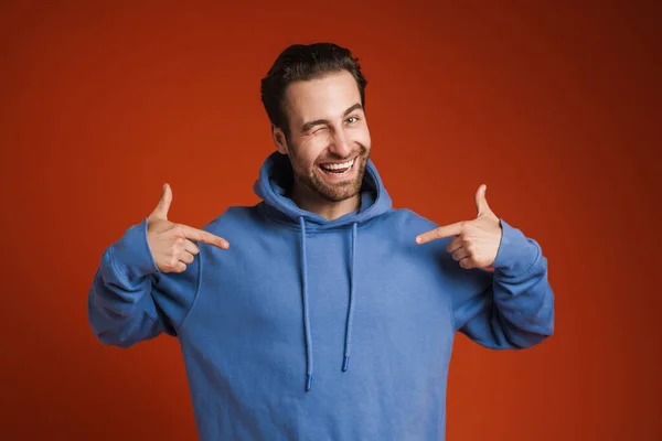 Young Bristle Man Winking Pointing Fingers Himself Isolated Red Background —  Fotos de Stock