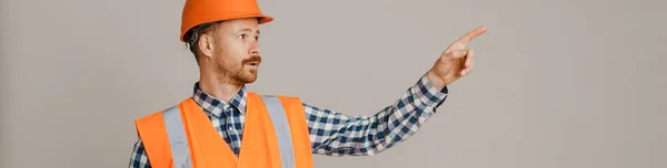 White Man Worker Wearing Helmet Pointing Finger Aside Isolated Grey — Fotografia de Stock