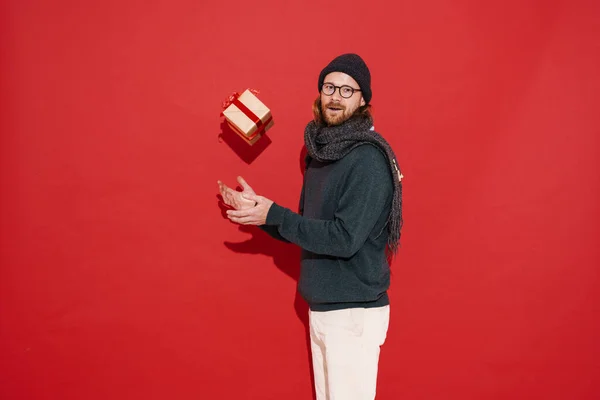 White Man Warm Clothes Eyeglasses Posing Gift Box Isolated Red — Fotografia de Stock