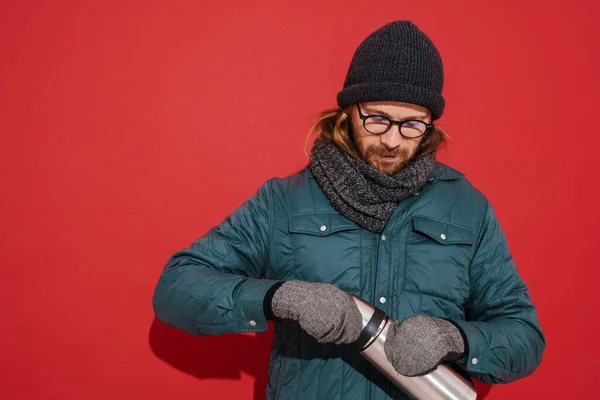 White Man Wearing Warm Clothes Opening His Thermos Isolated Red — Foto de Stock