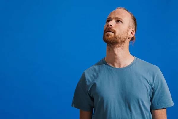 Ginger Puzzled Man Beard Posing Looking Upward Isolated Blue Background —  Fotos de Stock