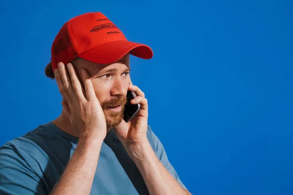 White Ginger Man Wearing Cap Talking Mobile Phone Isolated Blue — Fotografia de Stock