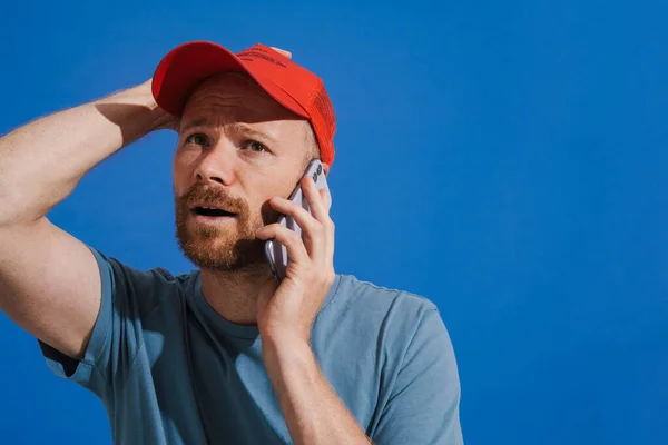 White Ginger Man Wearing Cap Talking Mobile Phone Isolated Blue — Fotografia de Stock