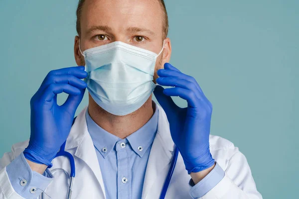 White Male Doctor Posing Face Mask Medical Gloves Isolated Blue — стоковое фото