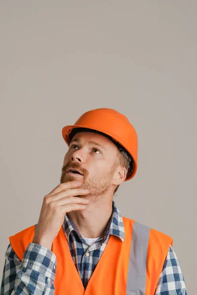 White Man Worker Wearing Helmet Vest Looking Upward Isolated Grey — Stok fotoğraf
