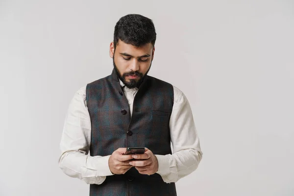Bearded South Asian Man Wearing Vest Using Cellphone Isolated White — 스톡 사진