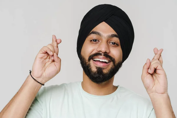 Bearded South Asian Man Wearing Turban Holding Fingers Crossed Isolated — ストック写真