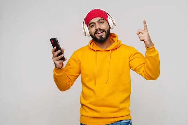 Bearded South Asian Man Dancing While Listening Music Headphones Isolated — Stockfoto