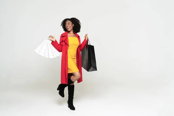 Young Black Woman Smiling While Walking Shopping Bags Isolated White — Stock Fotó
