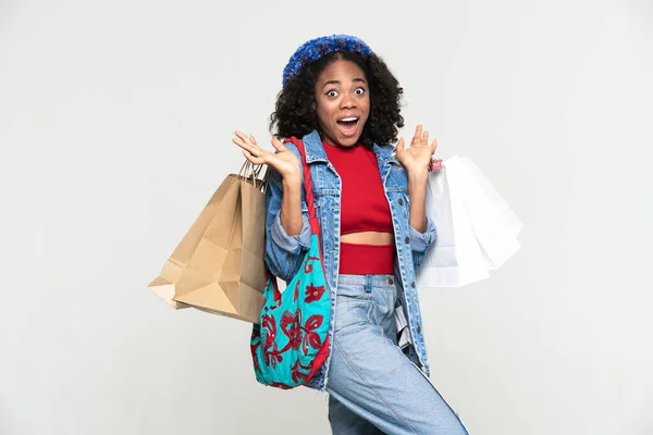 Black Woman Expressing Surprise While Posing Shopping Bags Isolated White — Stockfoto