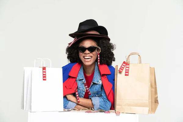 Young Black Woman Laughing While Posing Shopping Bags Isolated White — Stockfoto