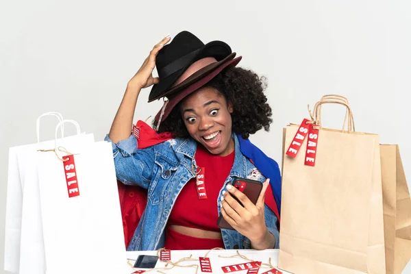 Black Woman Using Cellphone While Posing Shopping Bags Isolated White — Stock Fotó