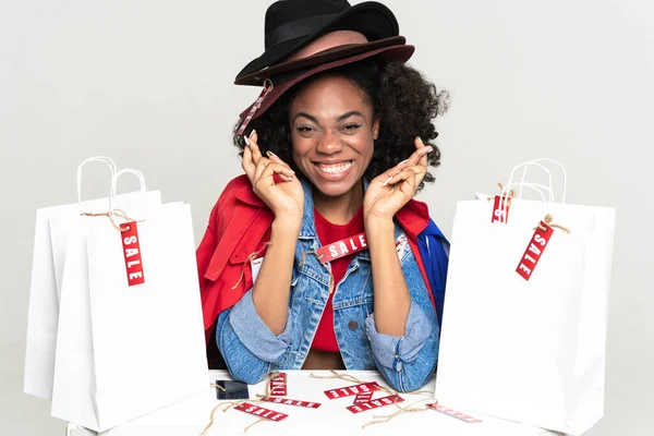 Young Black Woman Gesturing While Posing Shopping Bags Isolated White — Stockfoto