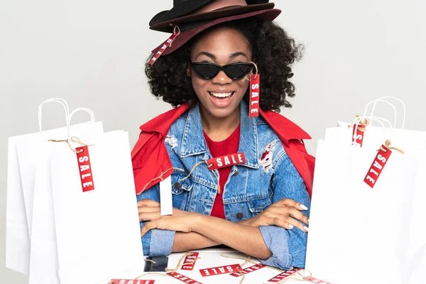 Young Black Woman Laughing While Posing Shopping Bags Isolated White — Stockfoto
