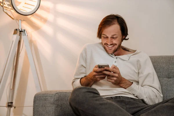 Ginger Bristle Man Using Mobile Phone While Resting Couch Home — Foto de Stock