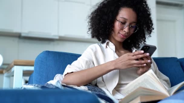 Pretty Curly Haired Woman Eyeglasses Texting Phone While Sitting Sofa — Stockvideo