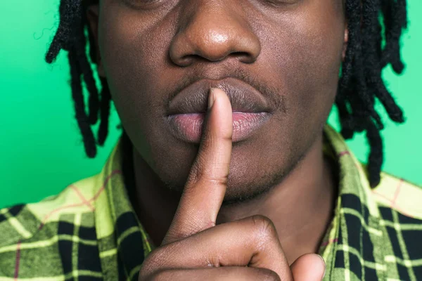 Young Black Man Dreadlocks Showing Silence Gesture Isolated Green Background — стоковое фото