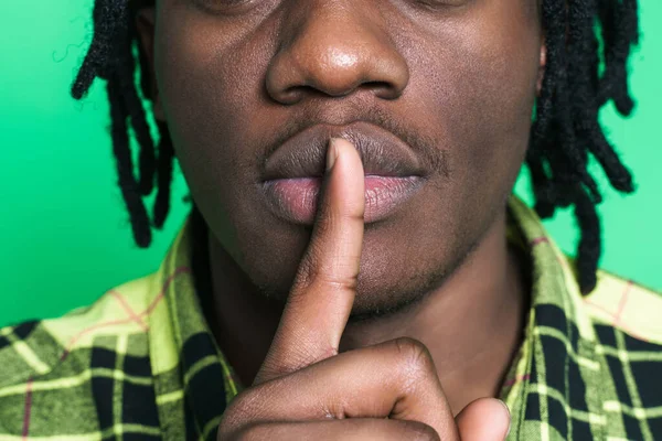 Young Black Man Dreadlocks Showing Silence Gesture Isolated Green Background — Zdjęcie stockowe