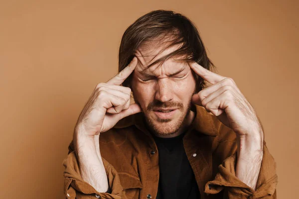 White Man Headache Rubbing His Temples Frowning Isolated Beige Background — стоковое фото