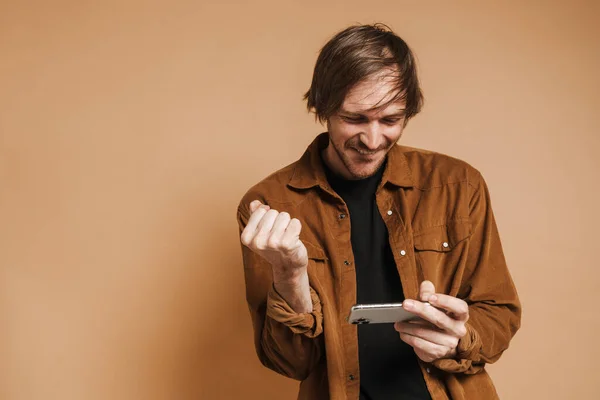 Bristle Man Making Winner Gesture While Playing Online Game Cellphone — Foto Stock