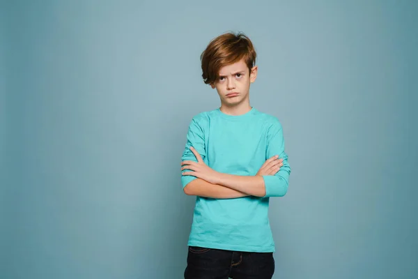 Ginger White Boy Frowning While Posing Arms Crossed Isolated Blue — Stock fotografie