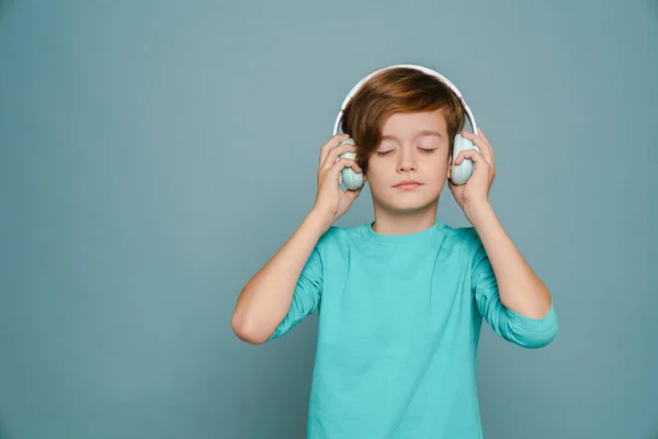 Ginger White Boy Listening Music Headphones Isolated Blue Wall — Foto de Stock