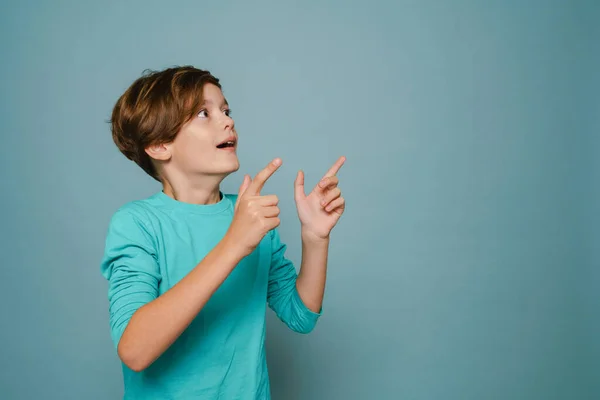 Ginger Shocked Boy Looking Pointing Fingers Aside Isolated Blue Wall — Fotografia de Stock