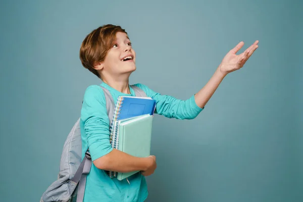 Ginger White Boy Gesturing While Posing Exercise Books Isolated Blue — стоковое фото