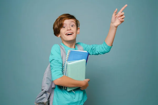 Ginger White Boy Gesturing While Posing Exercise Books Isolated Blue — Stockfoto